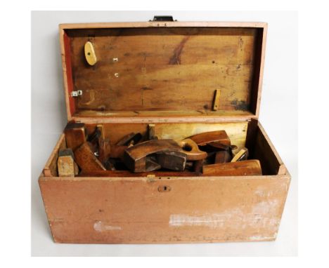 A large wooden tool box with a number of beech planes.