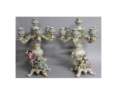 A PAIR OF "DRESDEN" PORCELAIN SEVEN LIGHT CANDELABRA with six scrolling branches, gallant and young lady to the base. 1ft 8in