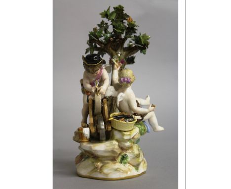 A GOOD MEISSEN GROUP OF CUPIDS, one sharpening an arrow on a wheel. Cross swords mark in blue. 8ins high.