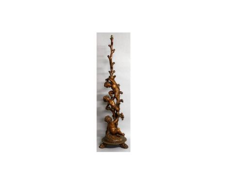 A SUPERB 18TH-19TH CENTURY ITALIAN CARVED WALNUT STANDARD LAMP with three cupids climbing a tree, on a circular base with thr