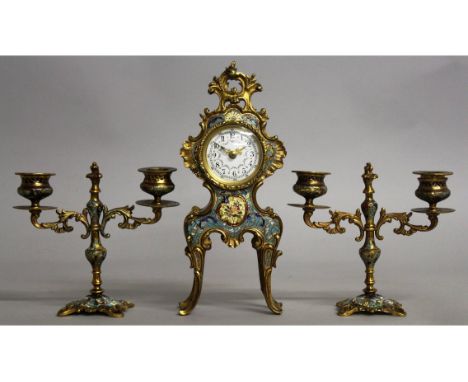 A SMALL 19TH CENTURY FRENCH ORMOLU AND CHAMPLEVE ENAMEL THREE PIECE CLOCK SET, the clock with circular enamel dial and a drum