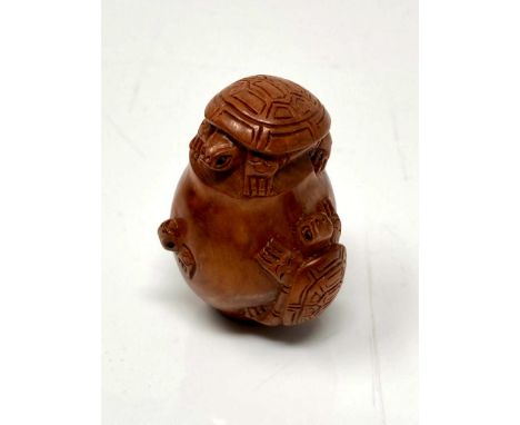 A carved Chinese hardwood netsuke - Turtle family in a pot 