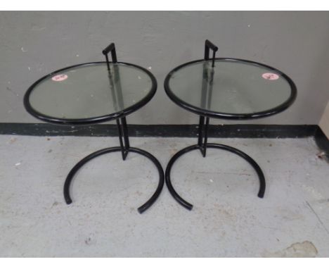 A pair of metal and glass circular lamp tables  