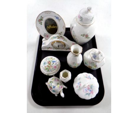 A tray containing Aynsley Wild Tudor mantel clock and photograph frame, lidded dressing table pot, figure of a tortoise, vase