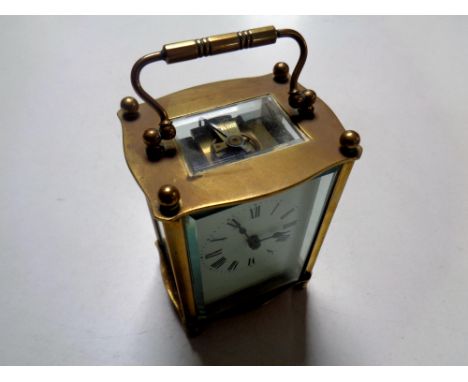 A brass cased French carriage clock with platform escapement and key 