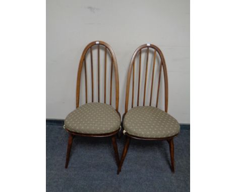A pair of Ercol spindle back dining chairs with cushions 