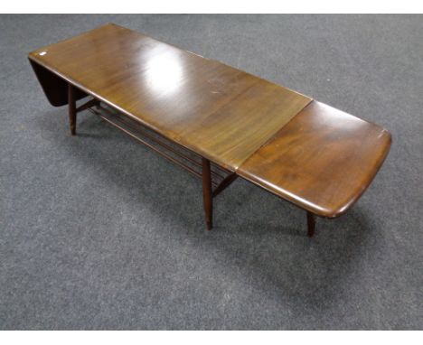 An Ercol low drop end coffee table fitted undershelf 