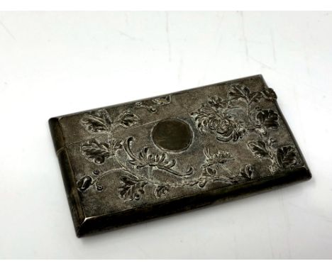 An Indian silver card case, of rectangular form, with embossed foliate and engine-turned decoration, length 8.5cm.  CONDITION