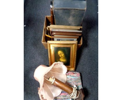 A box containing leather luggage case, pictures and prints, together with a clippy mat and a wooden table lamp  