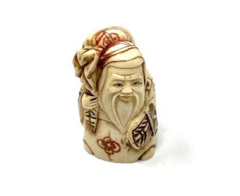 A carved Chinese bone netsuke - Village elder carrying a sack