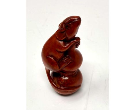 A carved Chinese hardwood netsuke - Rat climbing a post 