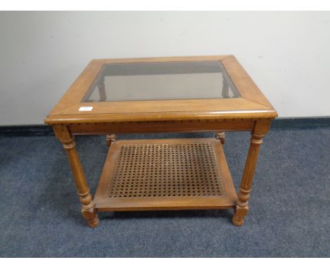 A contemporary bergere and glass topped lamp table 