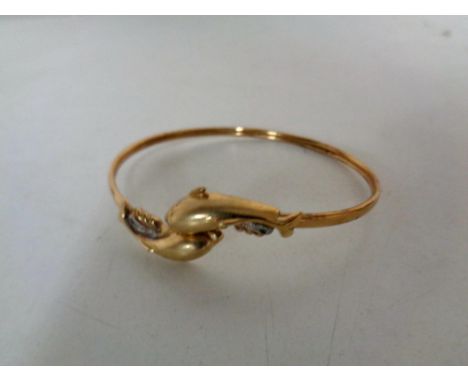 A 9ct gold dolphin bangle set with diamonds CONDITION REPORT: 7.4g