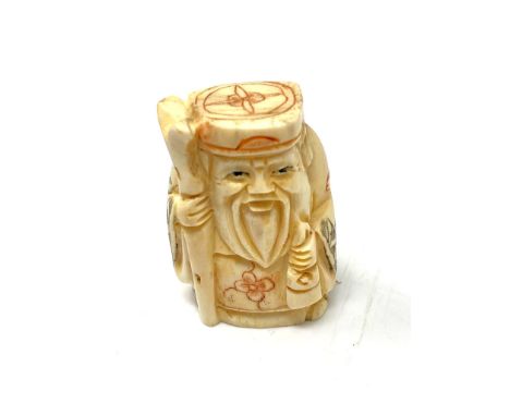 A carved Chinese bone netsuke - Bearded Gentleman with staff and gown