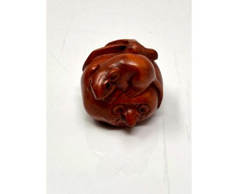 A carved Chinese hardwood netsuke - Two rats on fruit 