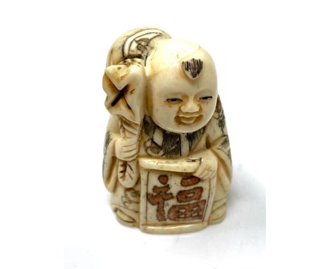 A carved Chinese bone netsuke - Village elder carrying a large bag