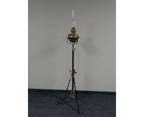 A wrought iron and brass standard oil lamp 