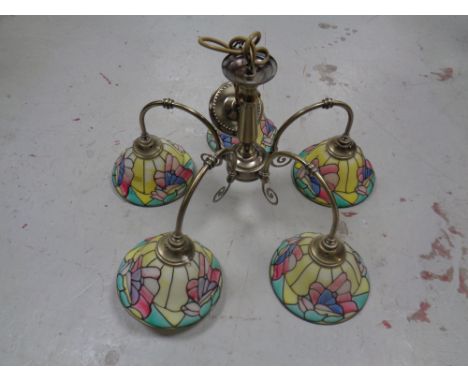 A contemporary ceiling light with five coloured glass shades  