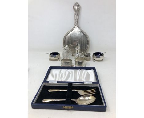 A pair of silver salts, a pepper pot, two napkin rings, a fork and spoon 6.6 ozt, a silver backed mirror, a glass mustard pot