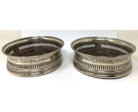 A pair of George III silver and mahogany bottle coasters, Robert Hennell, London 1812 Provenance: Sold with a Sander Lipton r