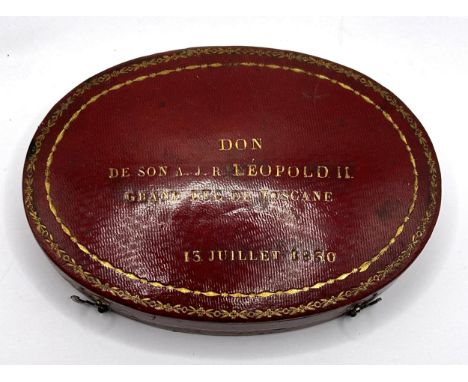 An early/mid 19th century French oval box, to hold two pocket watches, the cover tooled in gilt 'DON DE SON A J R LEOPOLD II,