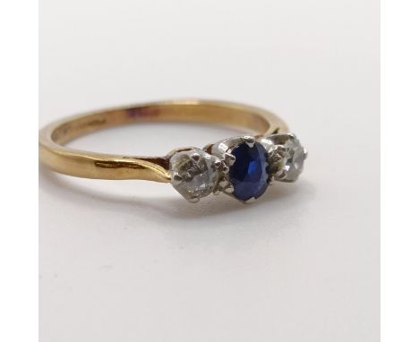 An 18ct gold, sapphire and diamond three stone ring, ring size K 