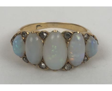 A gold and five stone opal ring, ring size N 