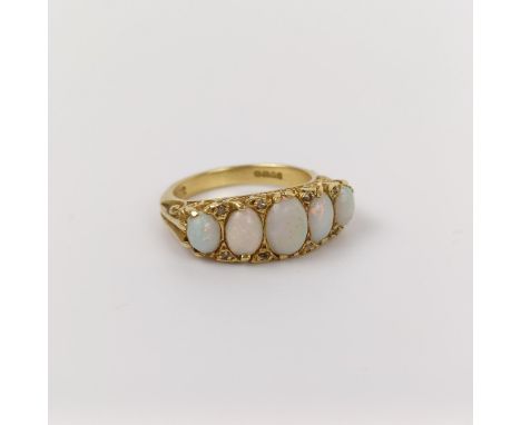 An 18ct gold and five stone opal ring, ring size L 
