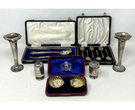 A set of six silver coffee spoons, cased, a pair of salts, a knife, fork and spoon, a mustard pot, two posy vases and a peppe
