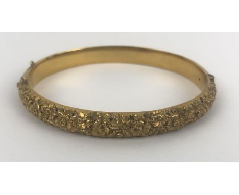 A Victorian 15ct gold hinged bangle, engraved with two sets of monogrammes and dated 21 11 89, 12.3 gof uniform shape, lackin