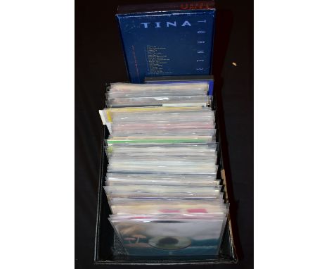 A TRAY CONTAINING APPROX NINETY SINGLES a CD boxset and two DVDs from the 1970s to 1980s artists include Free, Earl Vince and