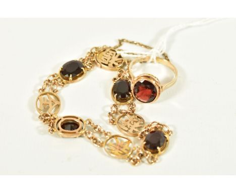 A GARNET RING AND BRACELET, the ring designed as an oval garnet in a collet setting to the pierced scrolling gallery, stamped