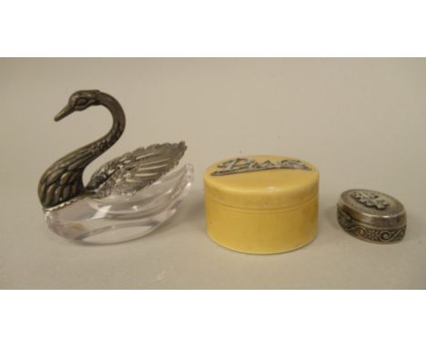 A celluloid pin box with a silver title; a silver coloured metal and cut glass swan design trinket box; and an oval patch box