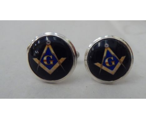 A pair of silver and enamel cufflinks, decorated with Masonic symbols&nbsp; 