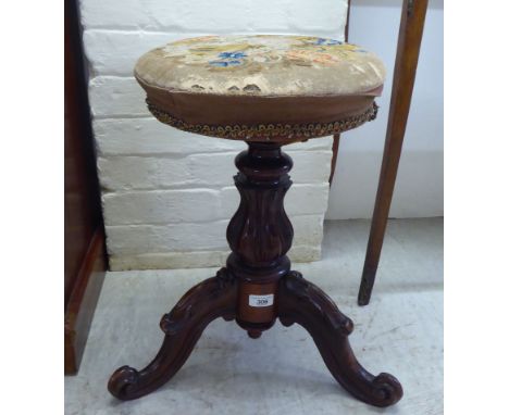 A late 19thC carved walnut framed revolving piano stool with a tapestry top, raised on a cabriole tripod base&nbsp; 