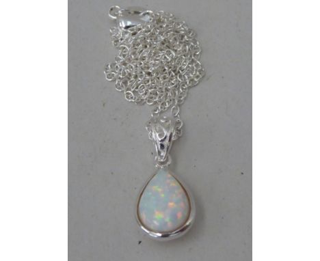 A silver coloured metal and opal set pendant, on a fine neckchain 