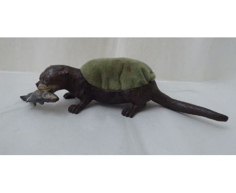 A painted cold cast bronze pin cushion, featuring an otter with a captured fish&nbsp; stamped Geschutzt 