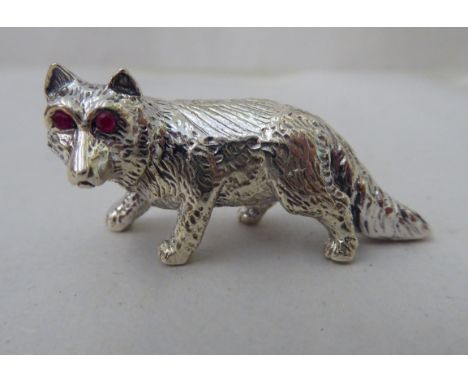 A Sterling silver miniature model, a prowling fox with ruby eyes 