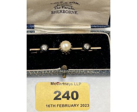 An antique 15ct bar brooch with a central size 16 pearl and two diamonds set in onyx. The diamonds 0.25ct each. 4.7g gross