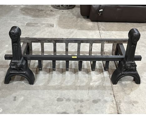 A pair of cast iron fire dogs with log grate. 44' wide