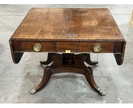 A Regency period rosewood and brass line inlaid sofa table, with two frieze drawers and two blind drawers, raised on a gadroo