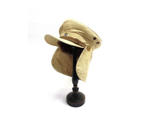 AN IMPERIAL GERMAN TROPICAL VISOR CAP  of sand-coloured cotton material, with a button-on nape guard, the long peak with a br