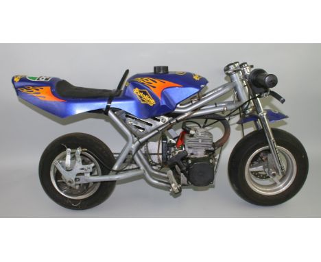 A child's blue motorcycle, engine number 6048580. We advise that a qualified mechanic checks over this vehicle.