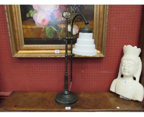 An iron frame table lamp of column form with milk glass stepped shade, 58cm tall