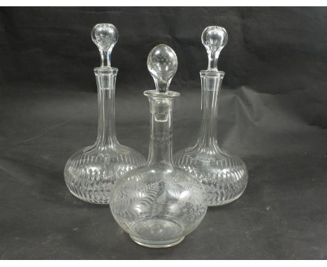 A pair of slice cut glass decanters and a fern etched decanter (3) 