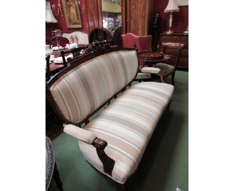 A mid Victorian walnut two seater sofa with ebony decoration, the turned finial's and carved back over carved scroll arms on 