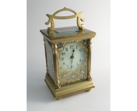 A late 19th/early 20th Century French brass carriage clock with Art Nouveau influenced case, enamel dial with arabic numerals