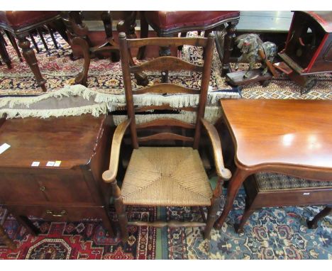 A 19th Century ladder back armchair with rush seat 