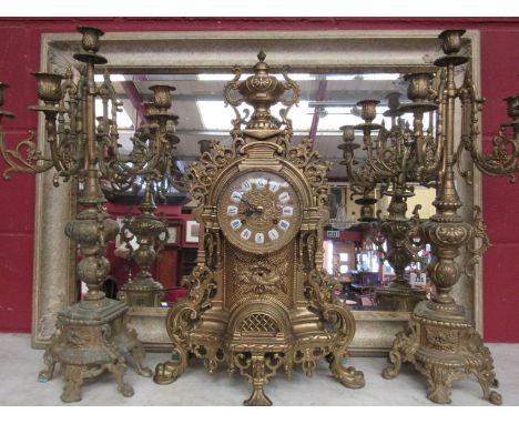 A 20th Century cast brass French clock with candlestick garniture, 59cm tall 