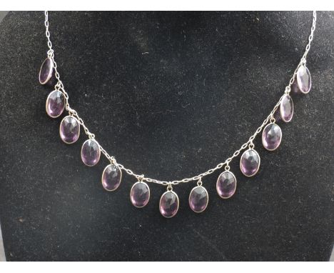 An amethyst drop necklace with 13 oval facetted cut stones 